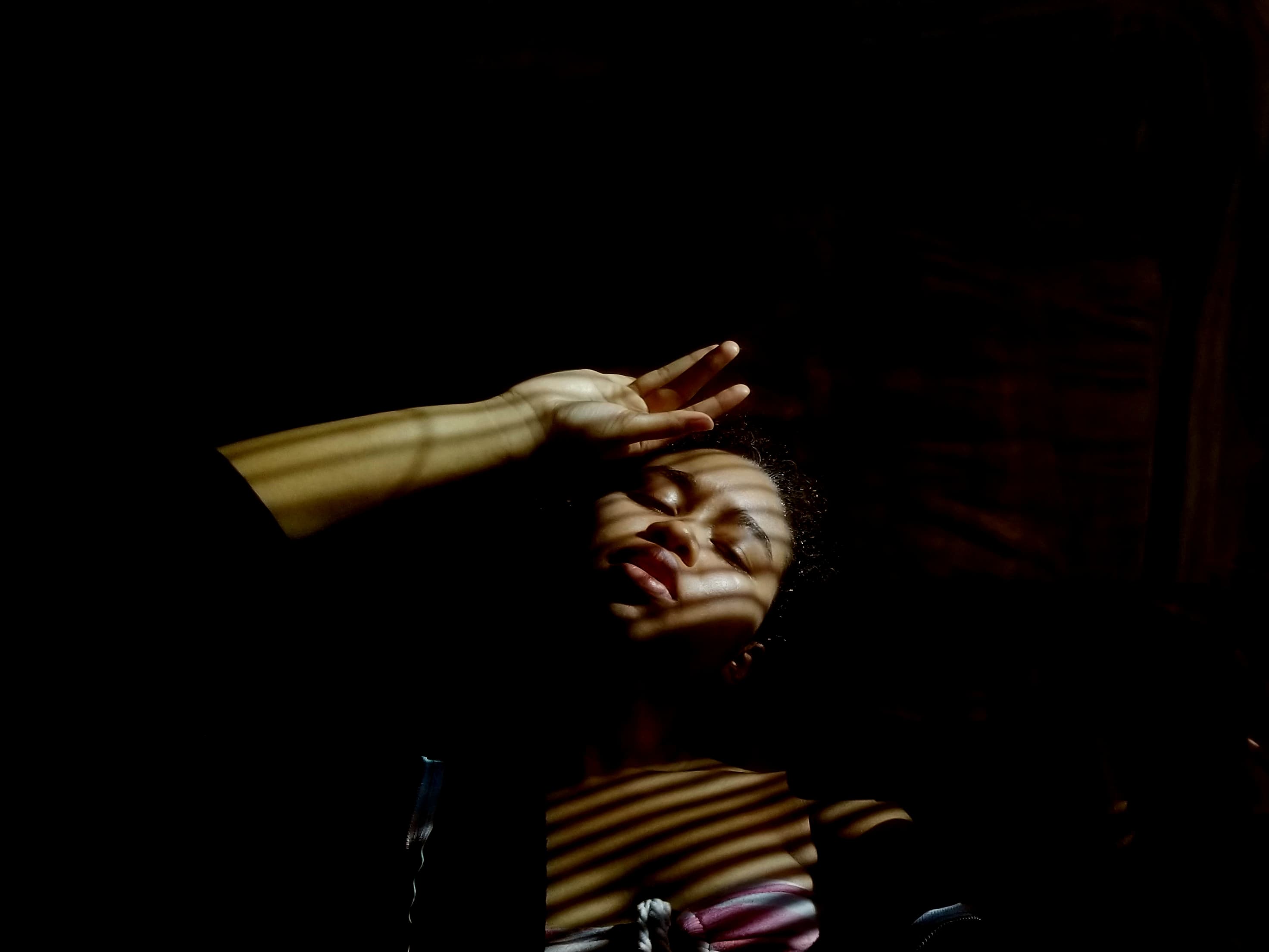 Hands reaching toward light